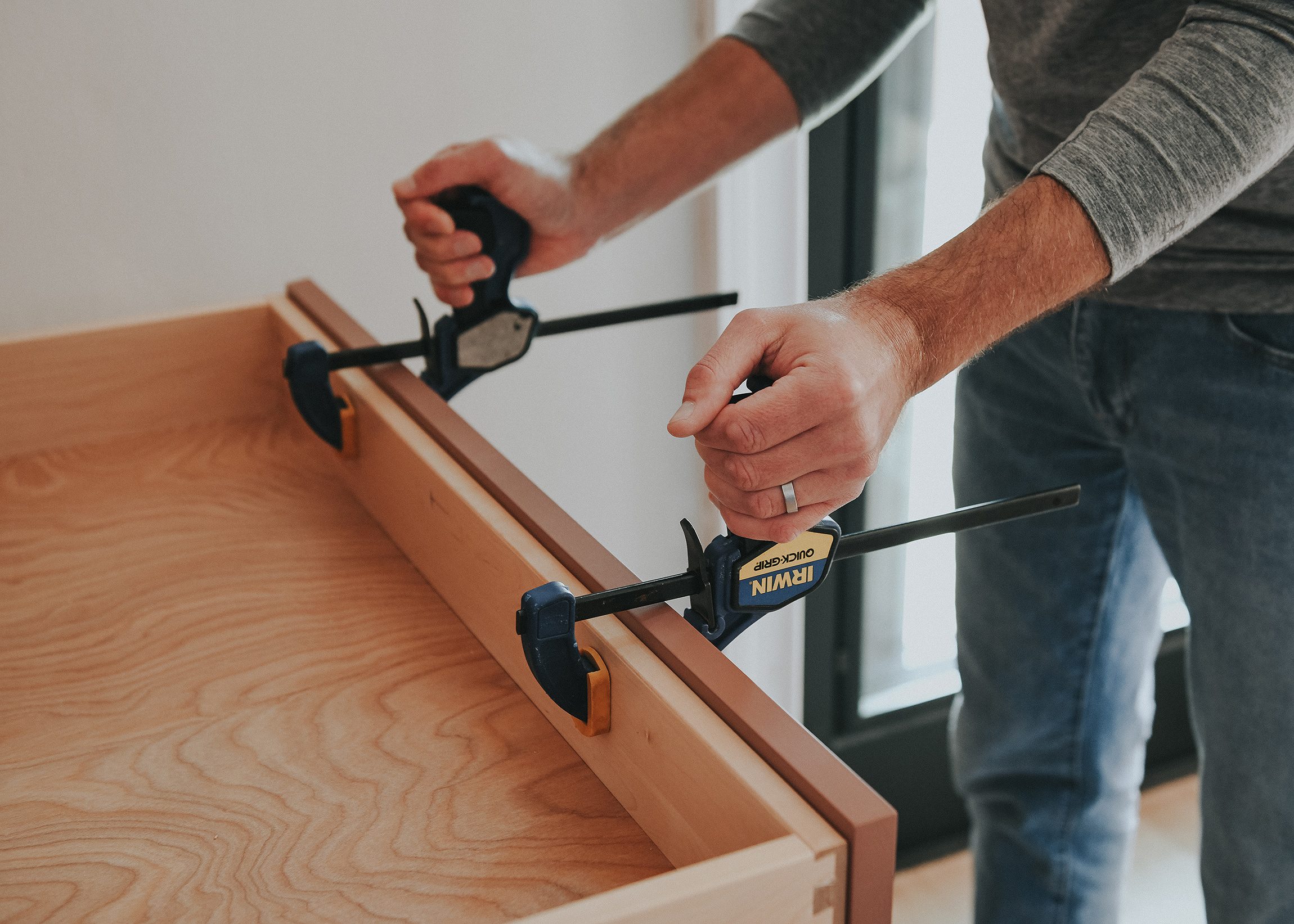 Scott clamps the drawer front onto the drawer box prior to fastening // via Yellow Brick Home