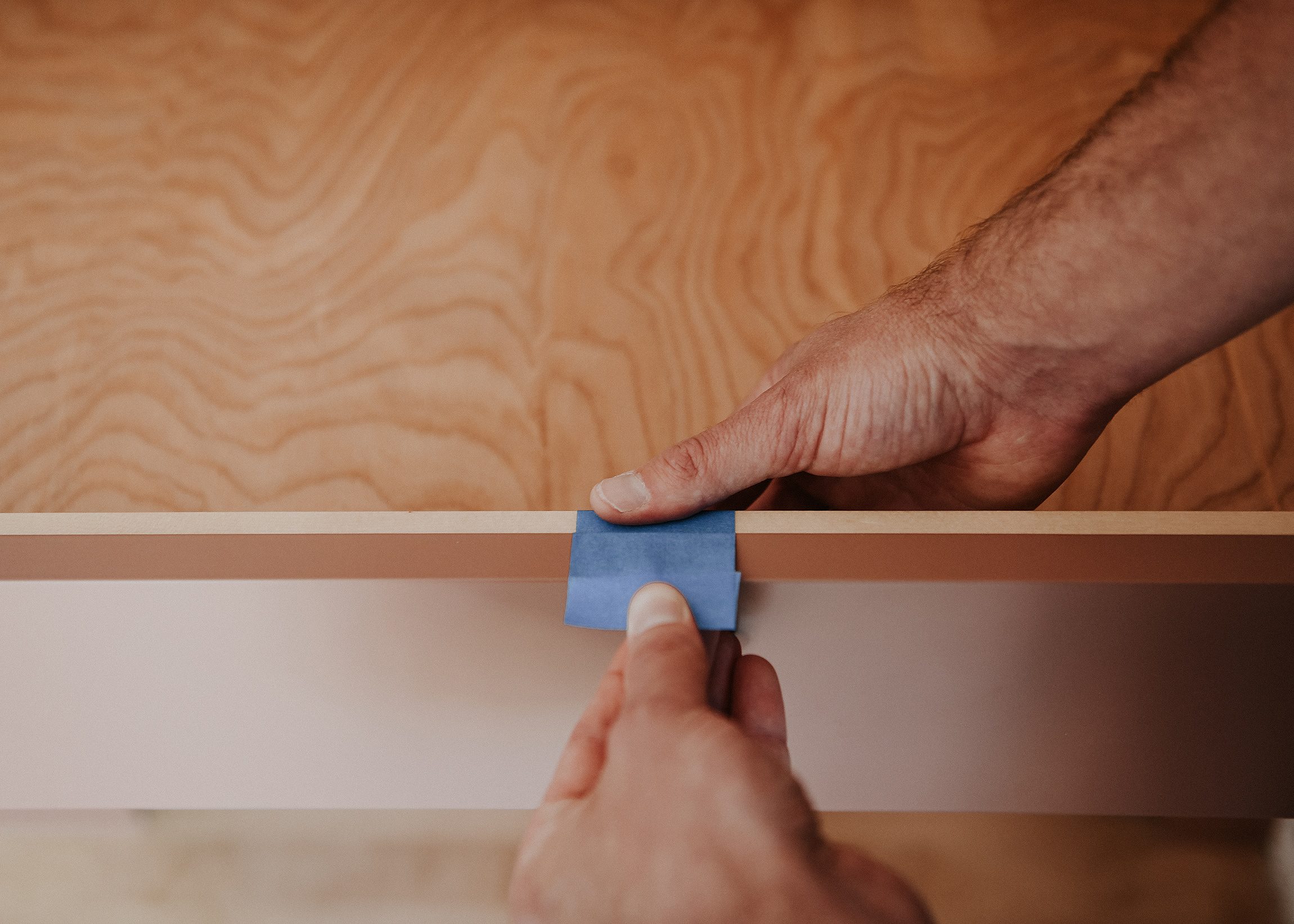 Scott creates a temporary drawer pull from blue painter's tape // via Yellow Brick Home