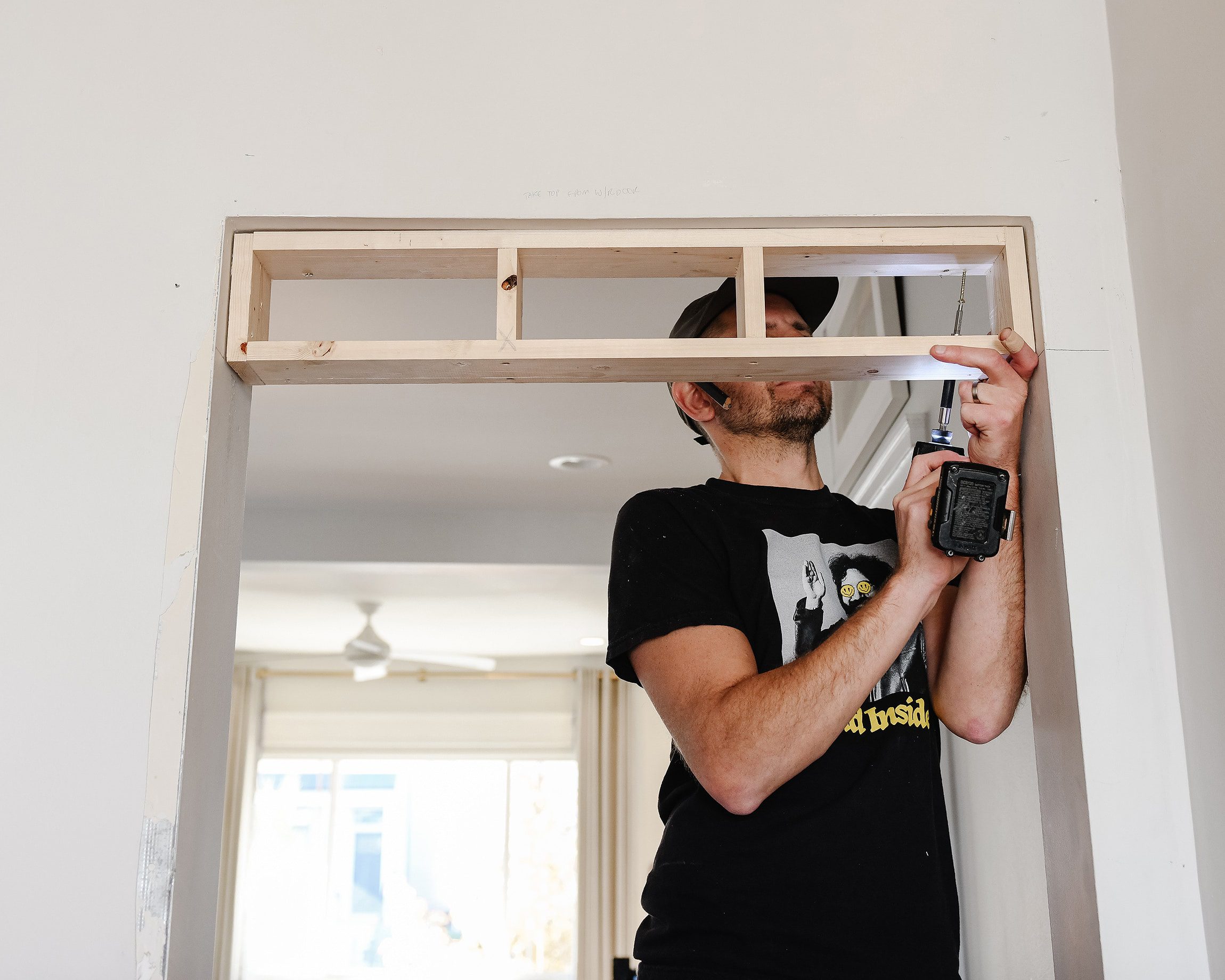 Scott installs a simple box to lower the vertical opening of the door so it lines up with other nearby doors // via yellow brick home