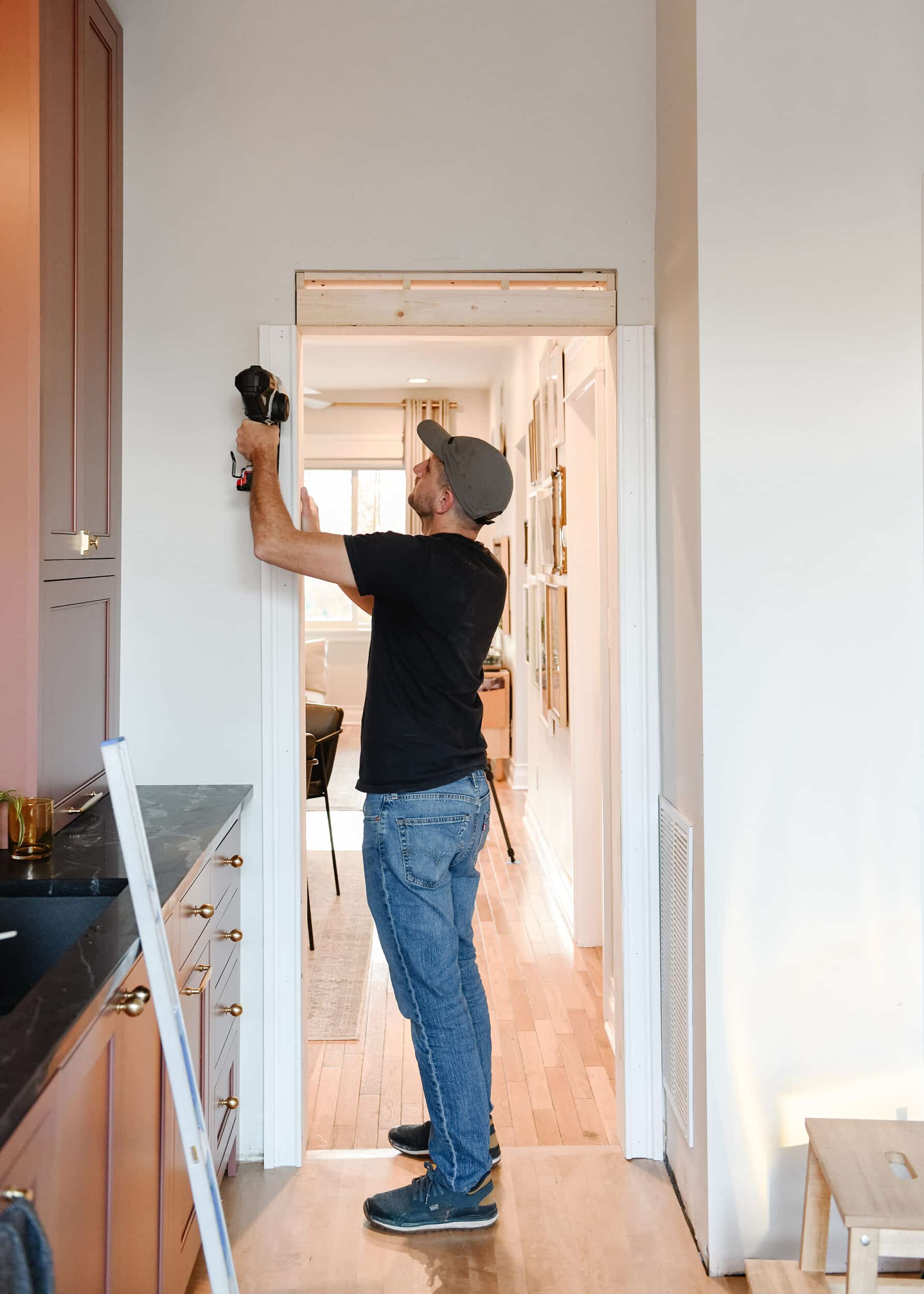 Scott nails the freshly shimmed casing into place // via yellow brick home