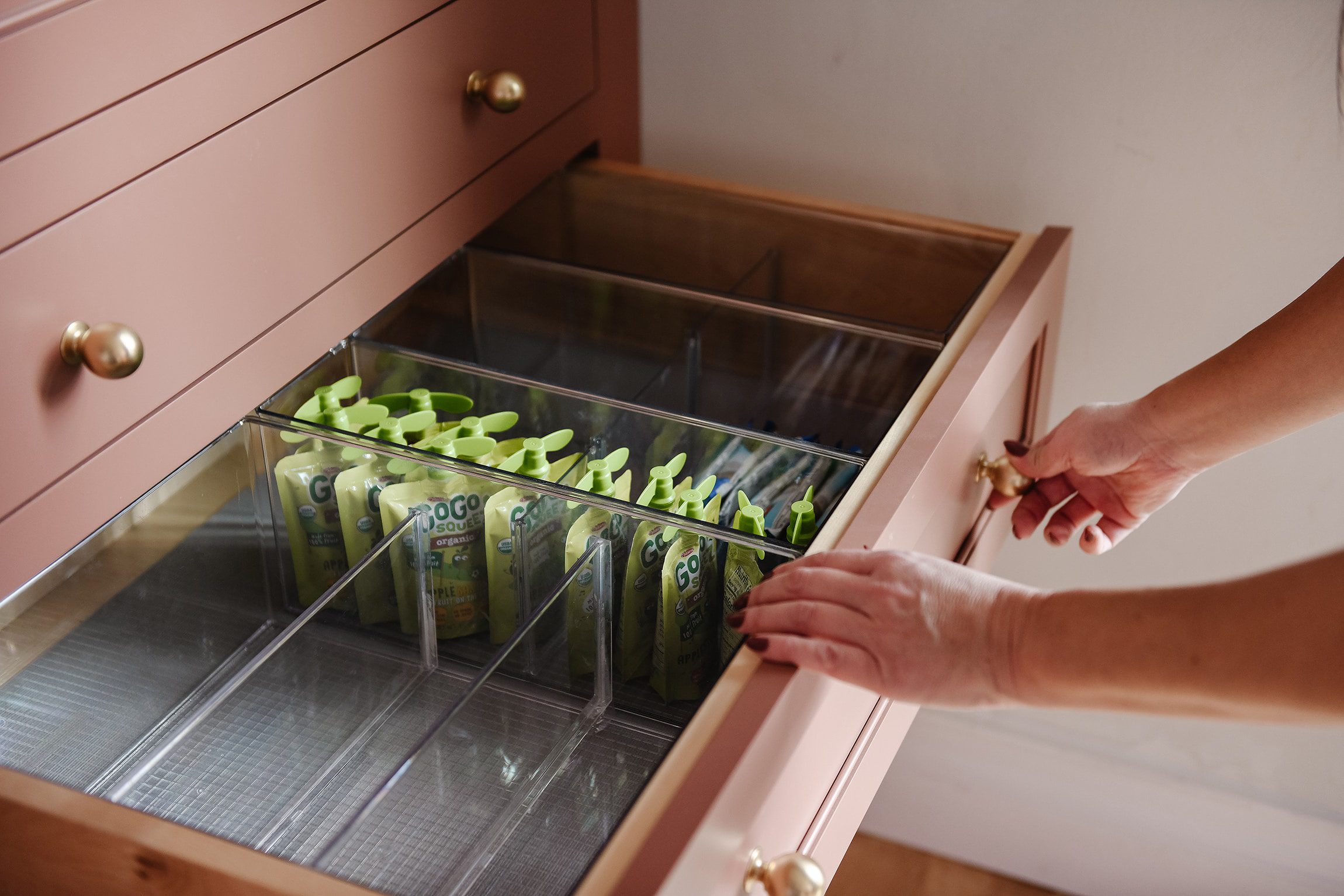 Try using clear acrylic bins for separating snacks! via Yellow Brick Home // kitchen organization ideas
