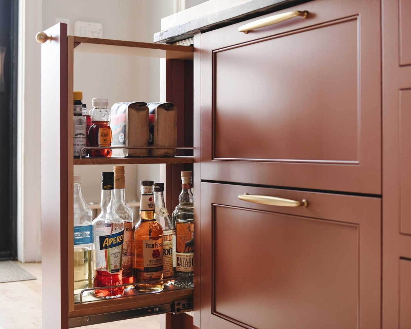 Our liquor cabinet and coffee storage in a pull out drawer, via Yellow Brick Home // kitchen organization ideas