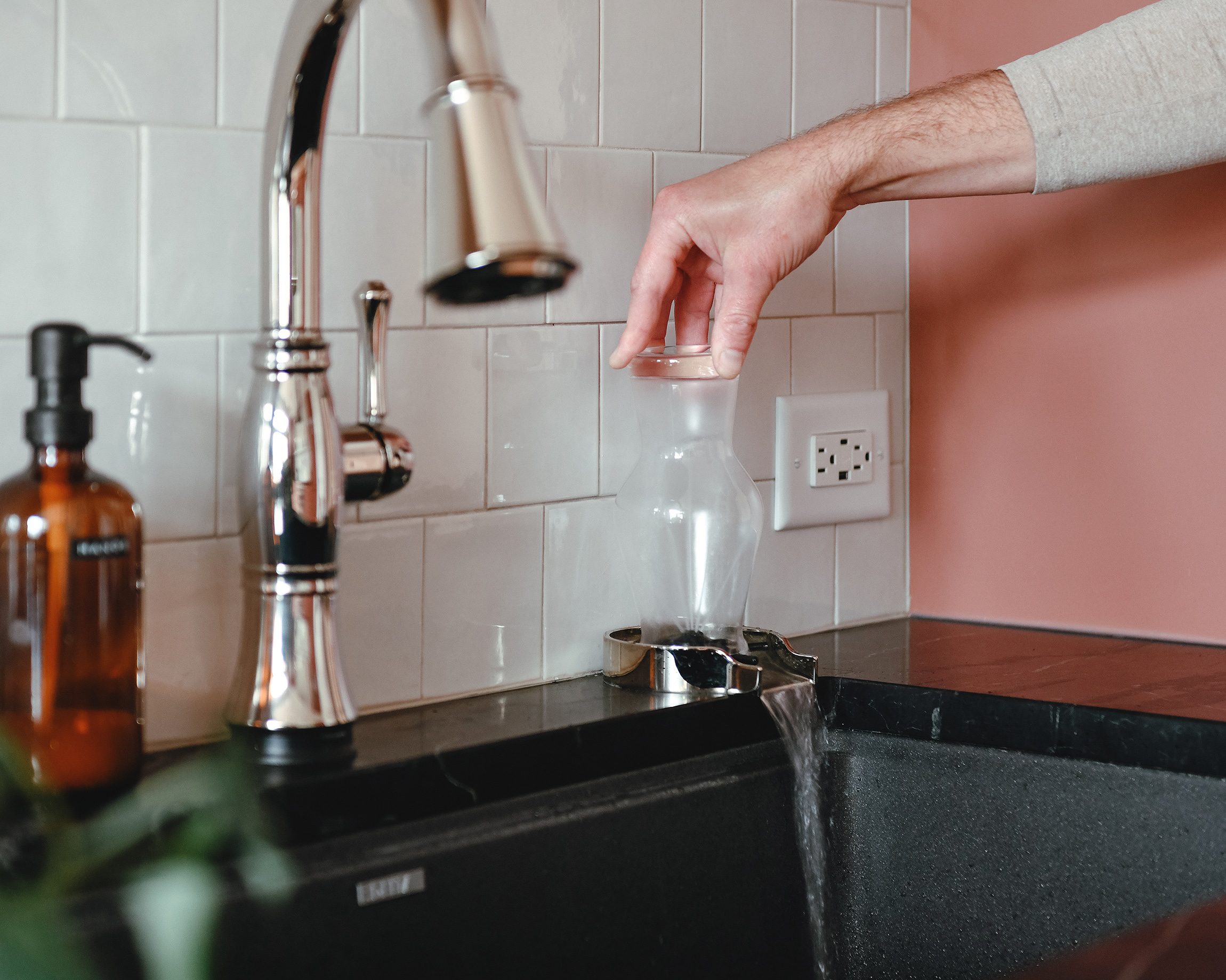 Scott rinses a specialty beer glass on our Delta glass rinser // via Yellow Brick Home