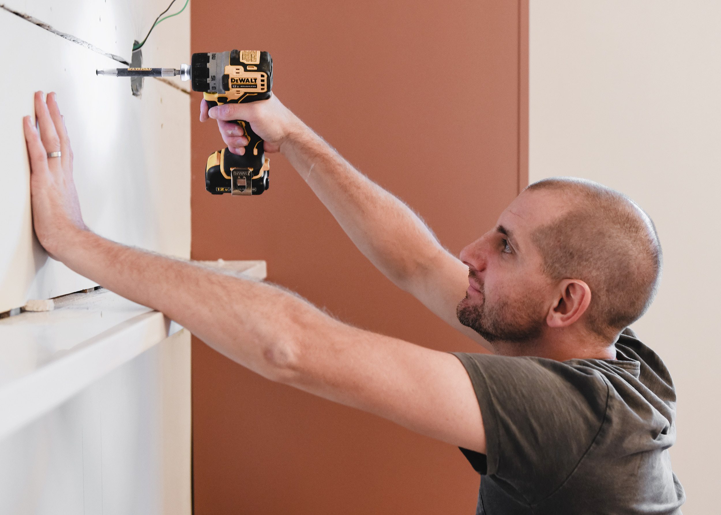 Scott re-installs the newly trimmed drywall patch // via Yellow Brick Home
