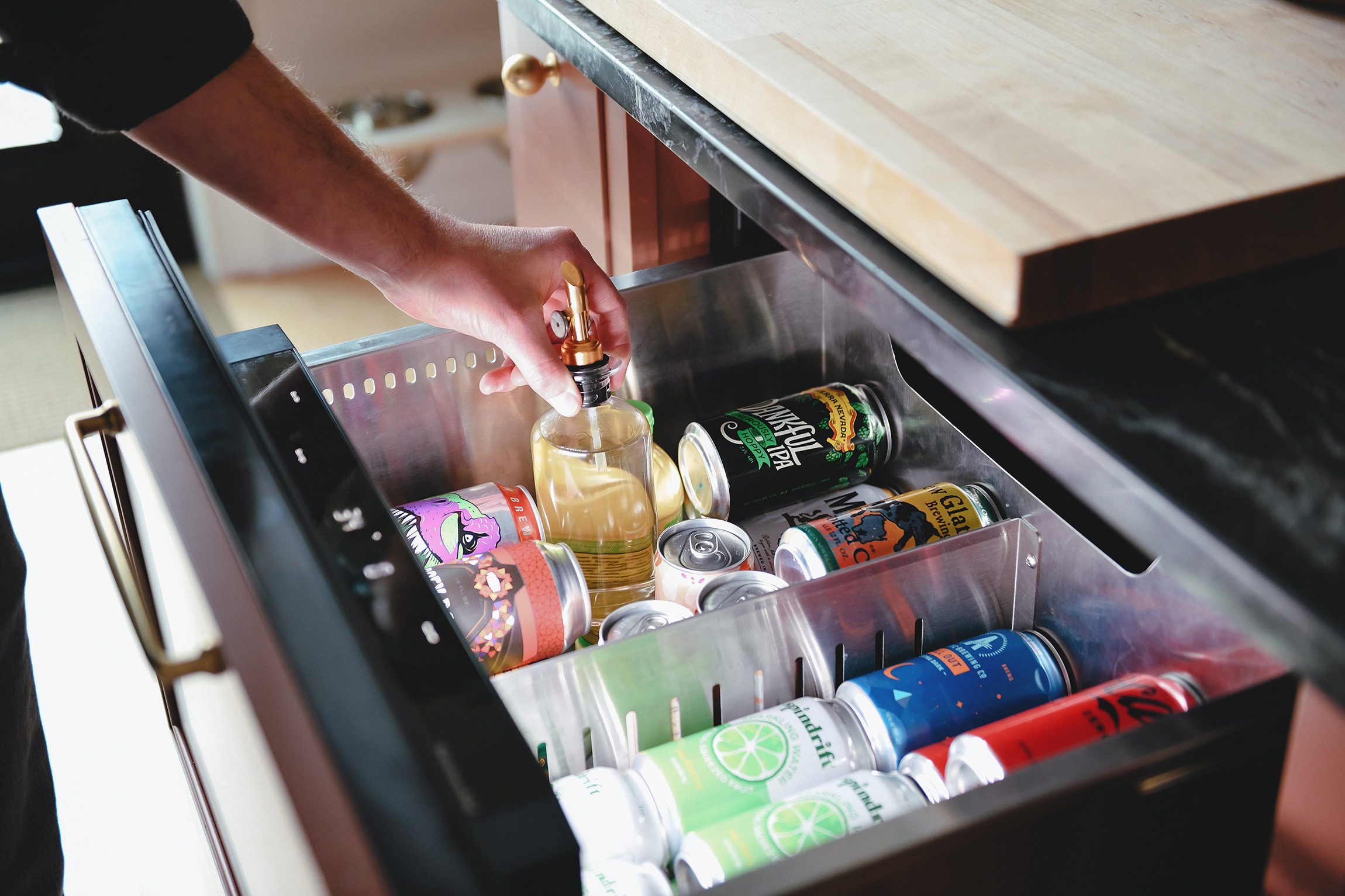 Scott grabs an item from the panel ready beverage fridge in our remodeled kitchen // via yellow brick home