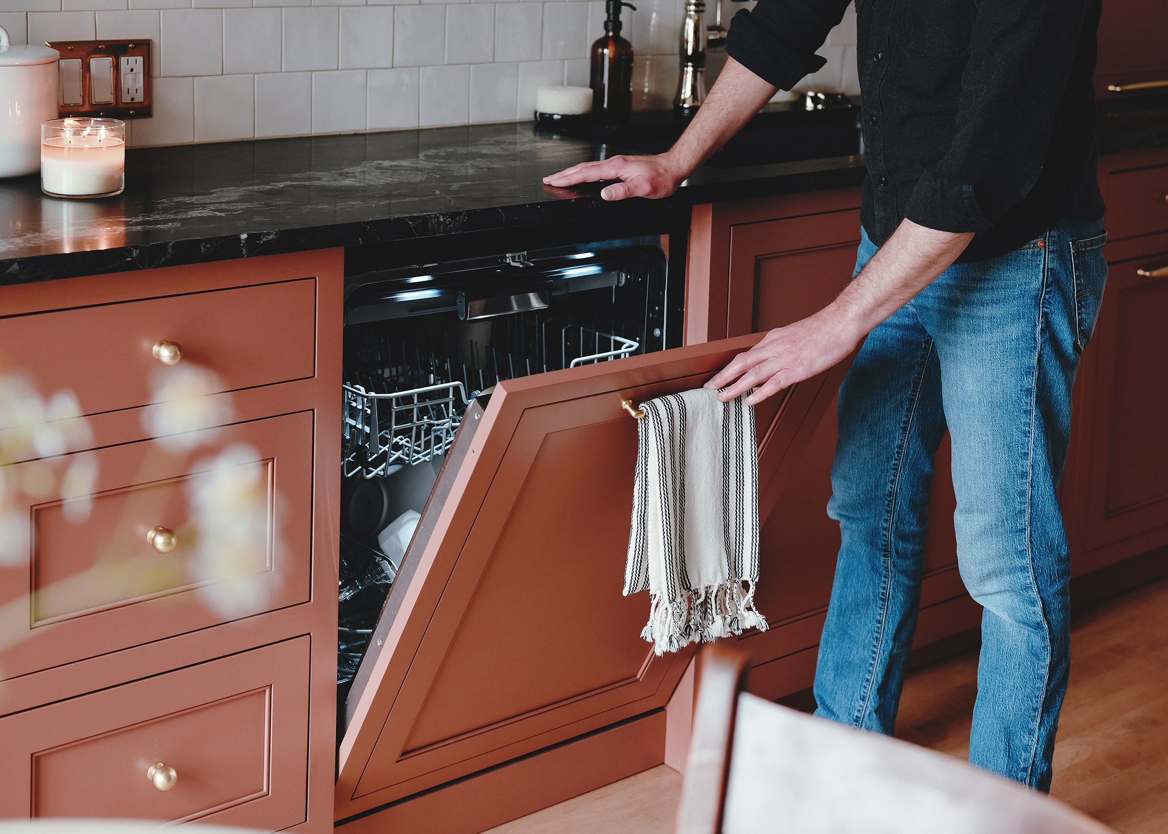 Scott loads the panel ready dishwasher in our newly renovated kitchen // via yellow brick home