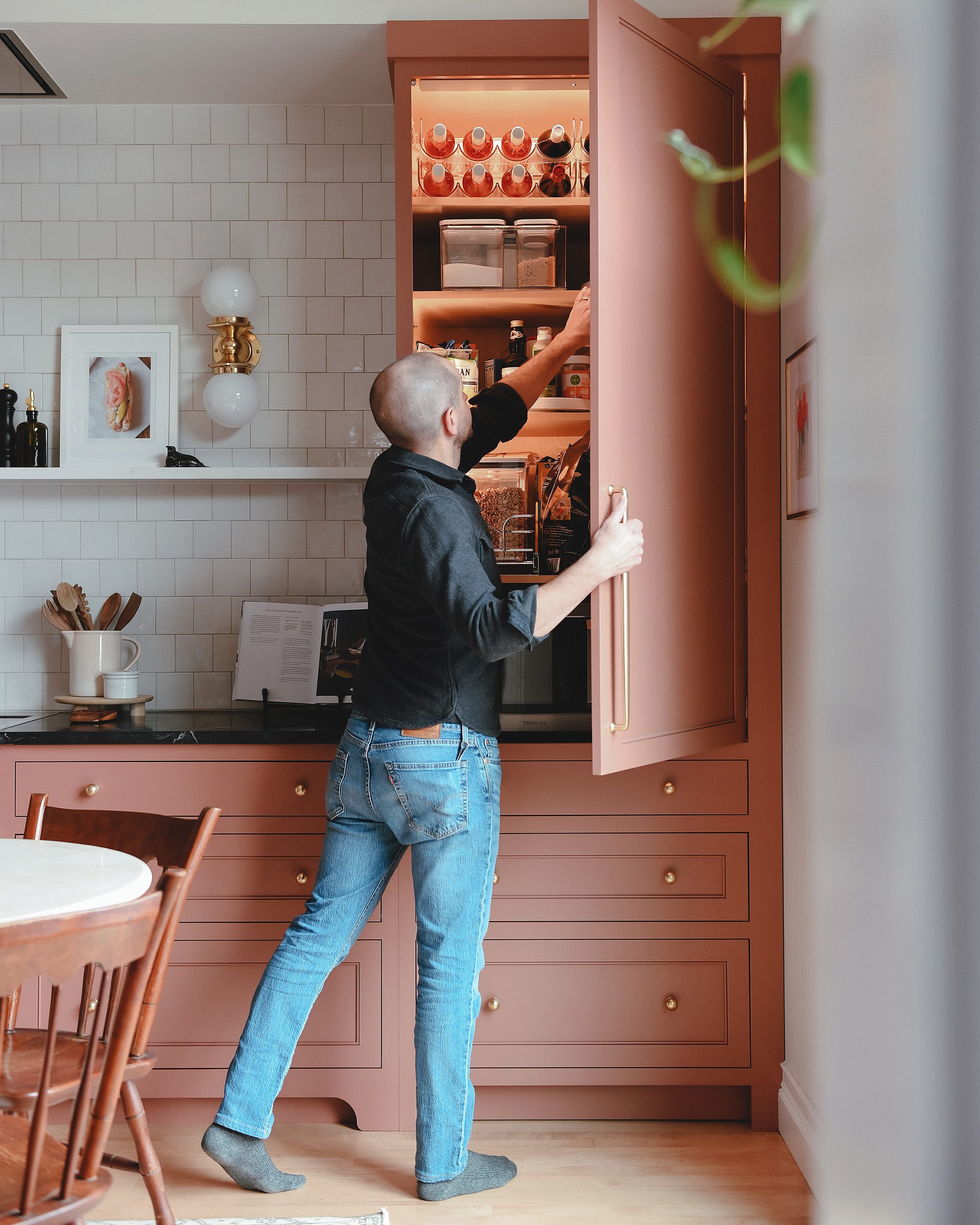 Scott grabs a snack from the pantry and shows off the automatic lighting in our newly renovated kitchen // via yellow brick home