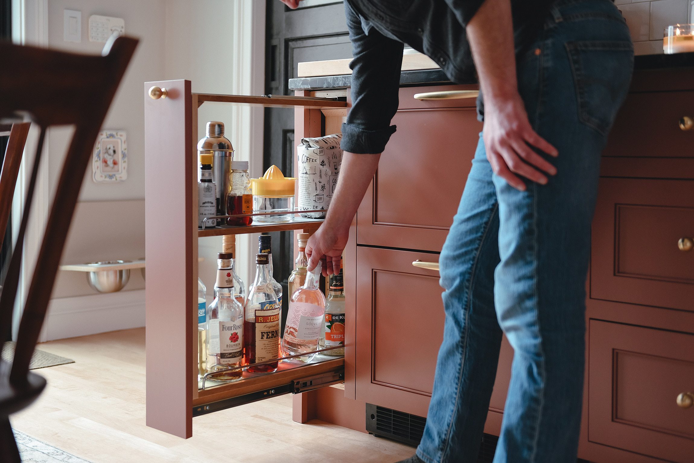 The pull-out liquor cabinet in our newly renovated kitchen // via Yellow Brick Home