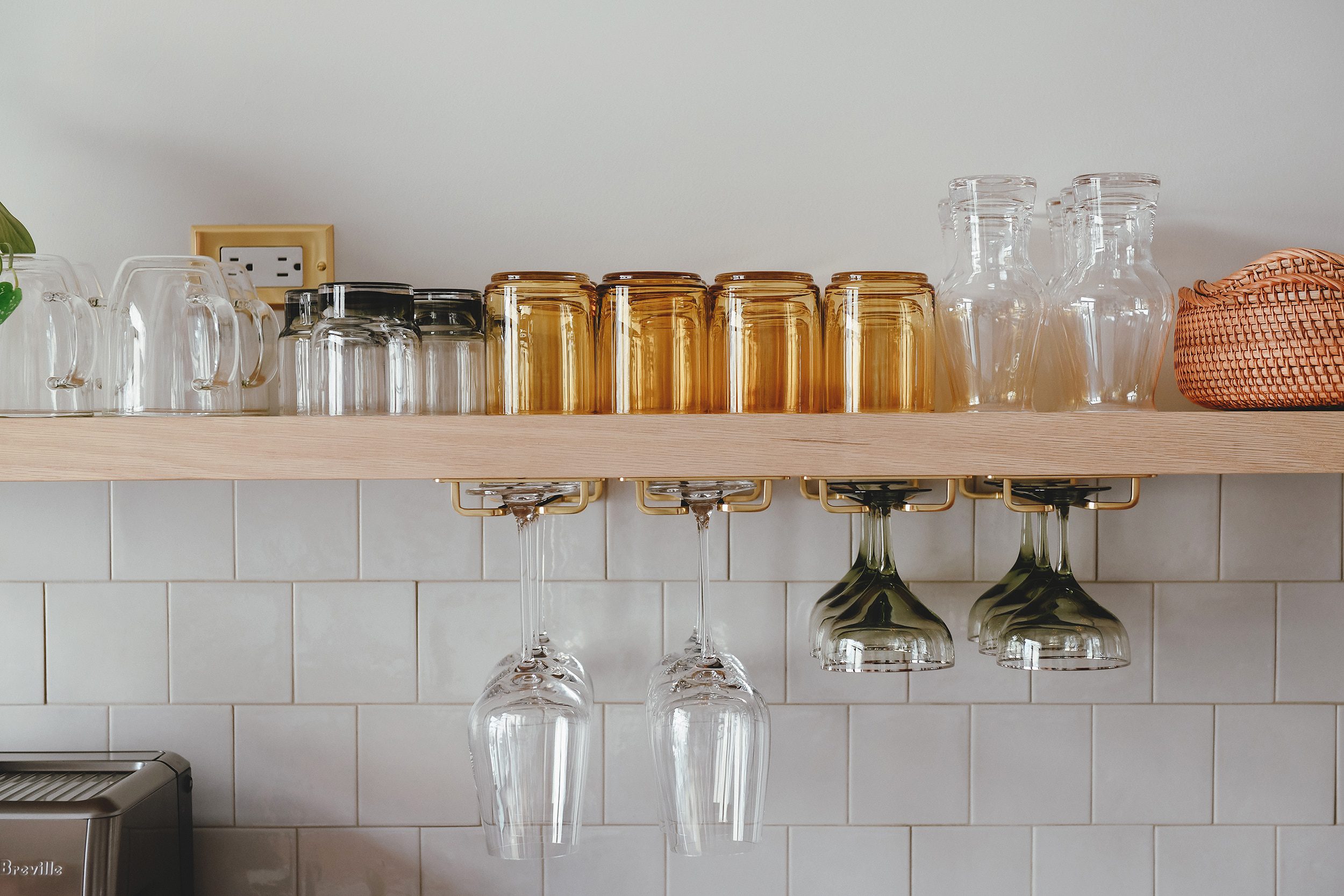 detail of our drinking glasses on our long floating shelf | via Yellow Brick Home