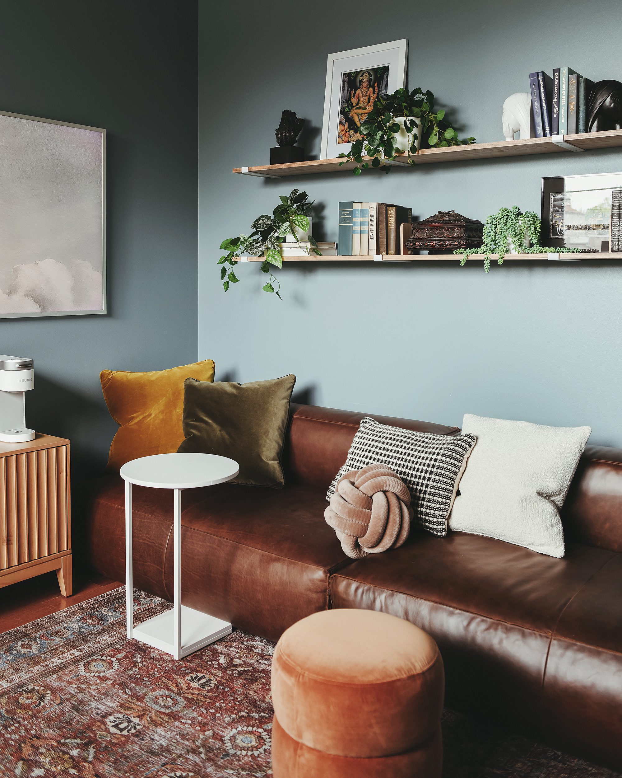 The 'after' view of the cozy leather sofa and built-in shelf wall // via Yellow Brick Home