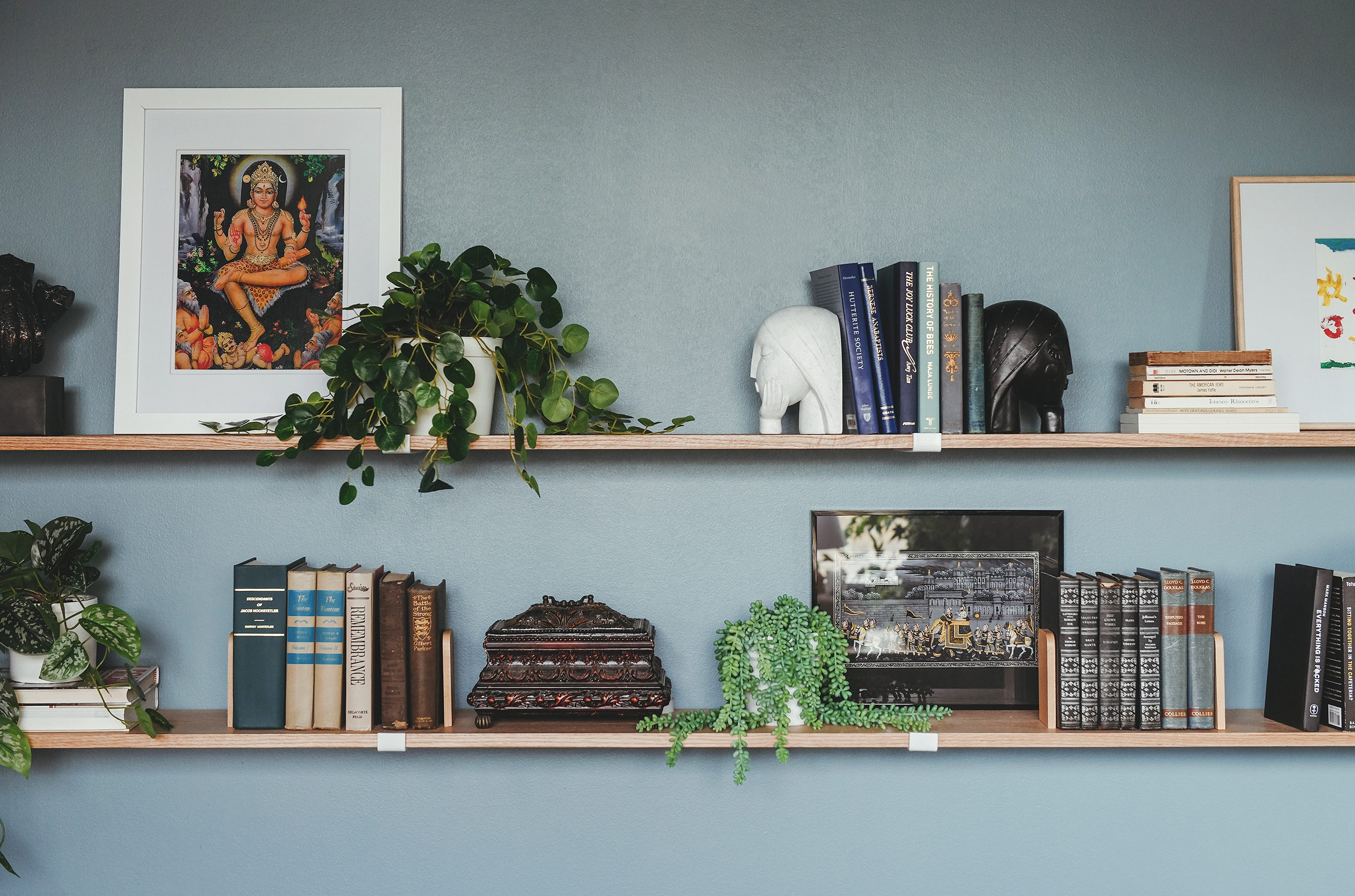 The custom oak shelving is full of books, family memories and found objects // via Yellow Brick Home
