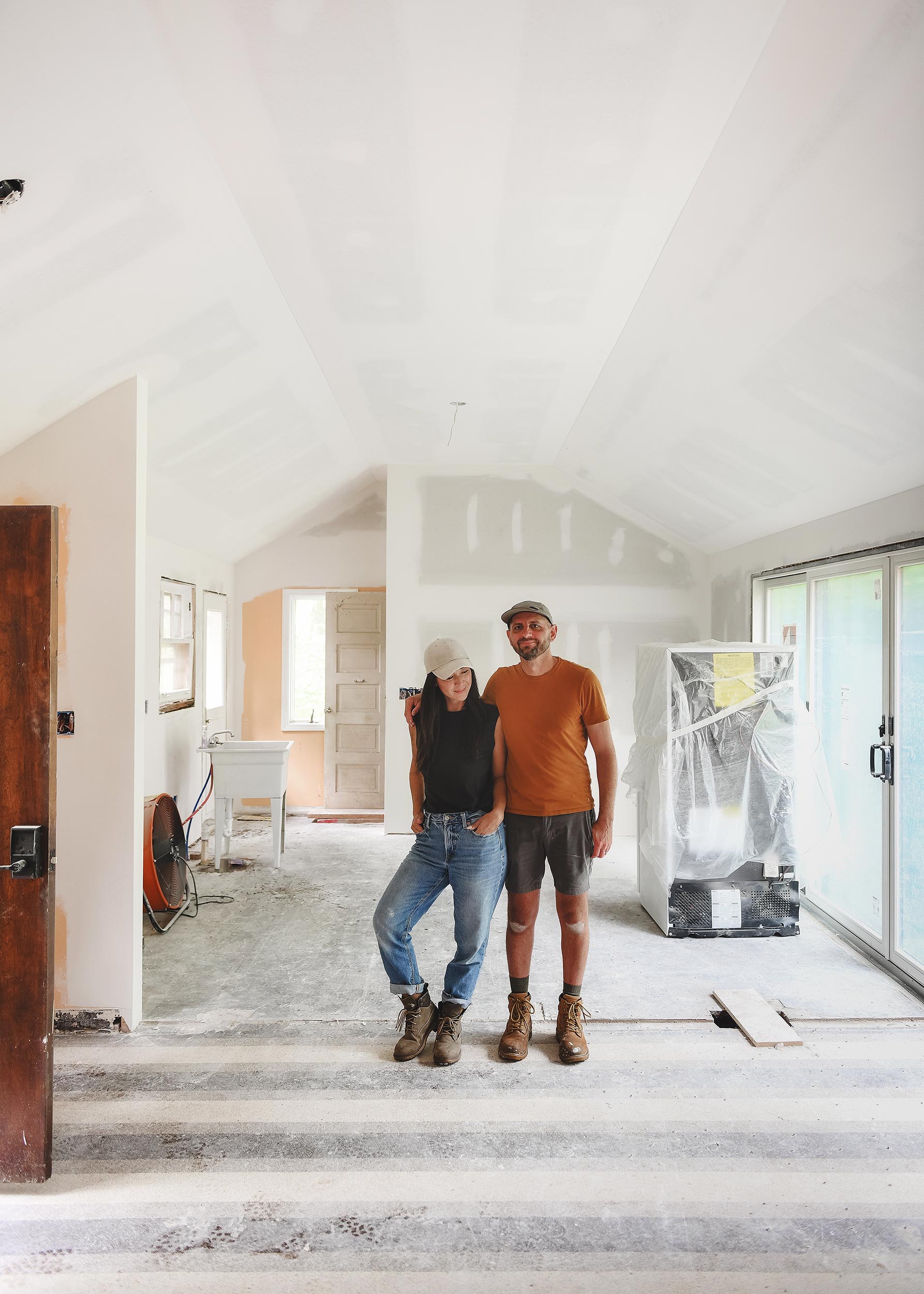 Kim and Scott in the main living space, mid-construction | via Yellow Brick Home