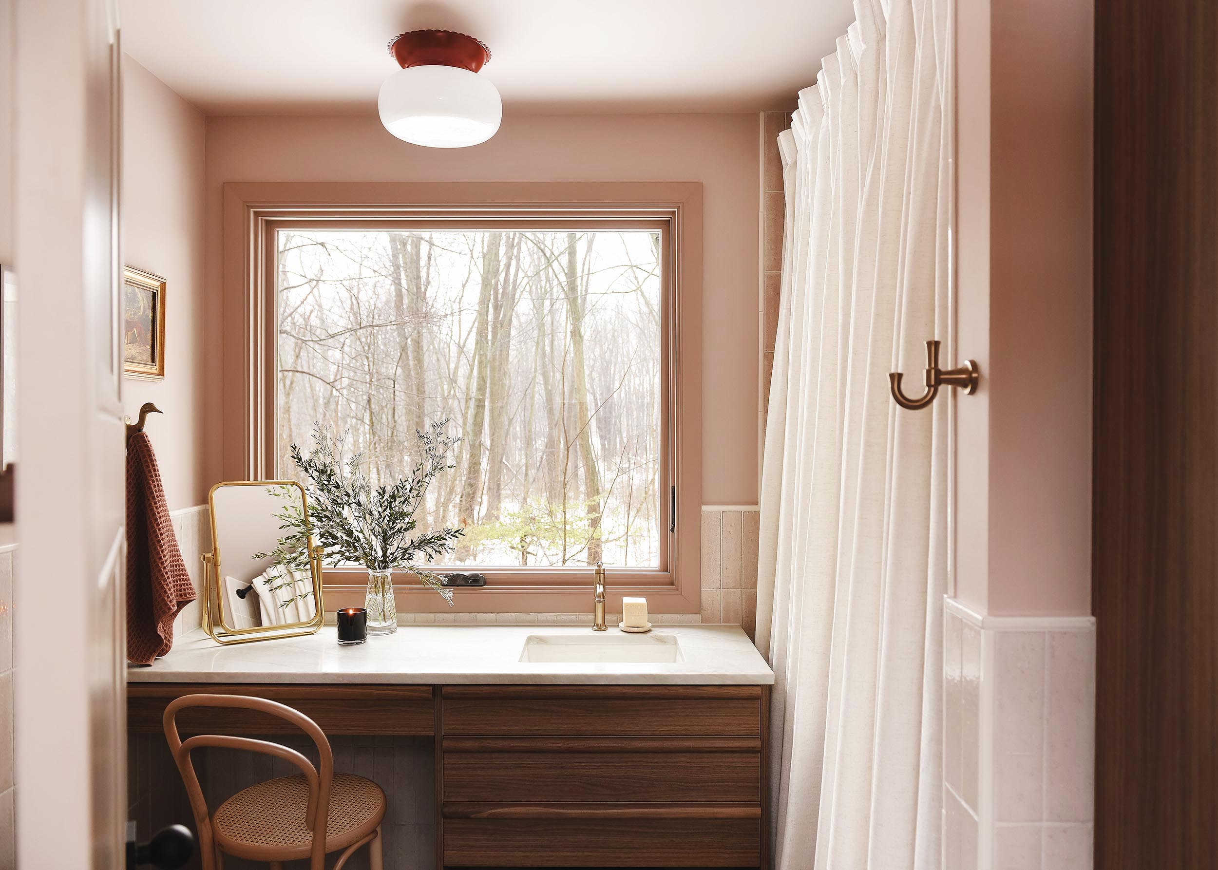 Vanity in a pink bathroom, walnut wood, terrazzo floors | via Yellow Brick Home
