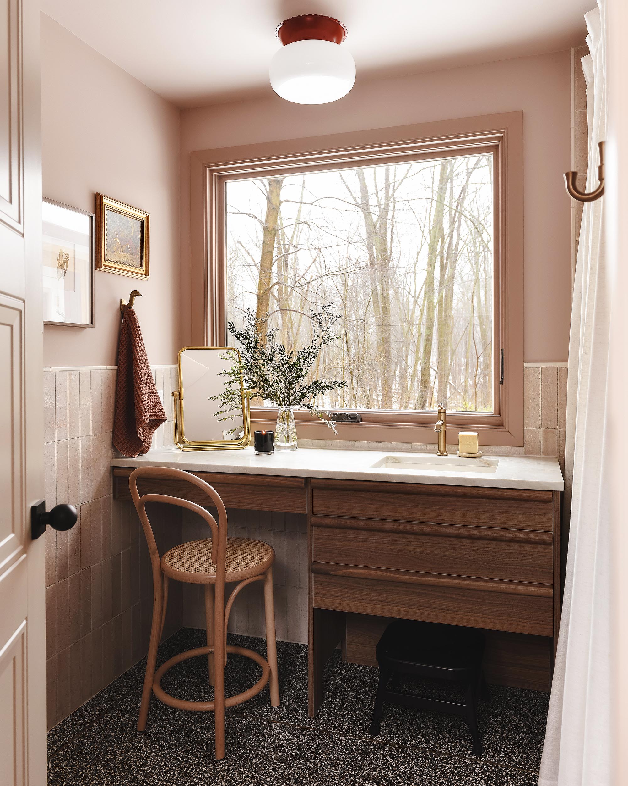 Vanity in a pink bathroom, walnut wood, terrazzo floors | via Yellow Brick Home
