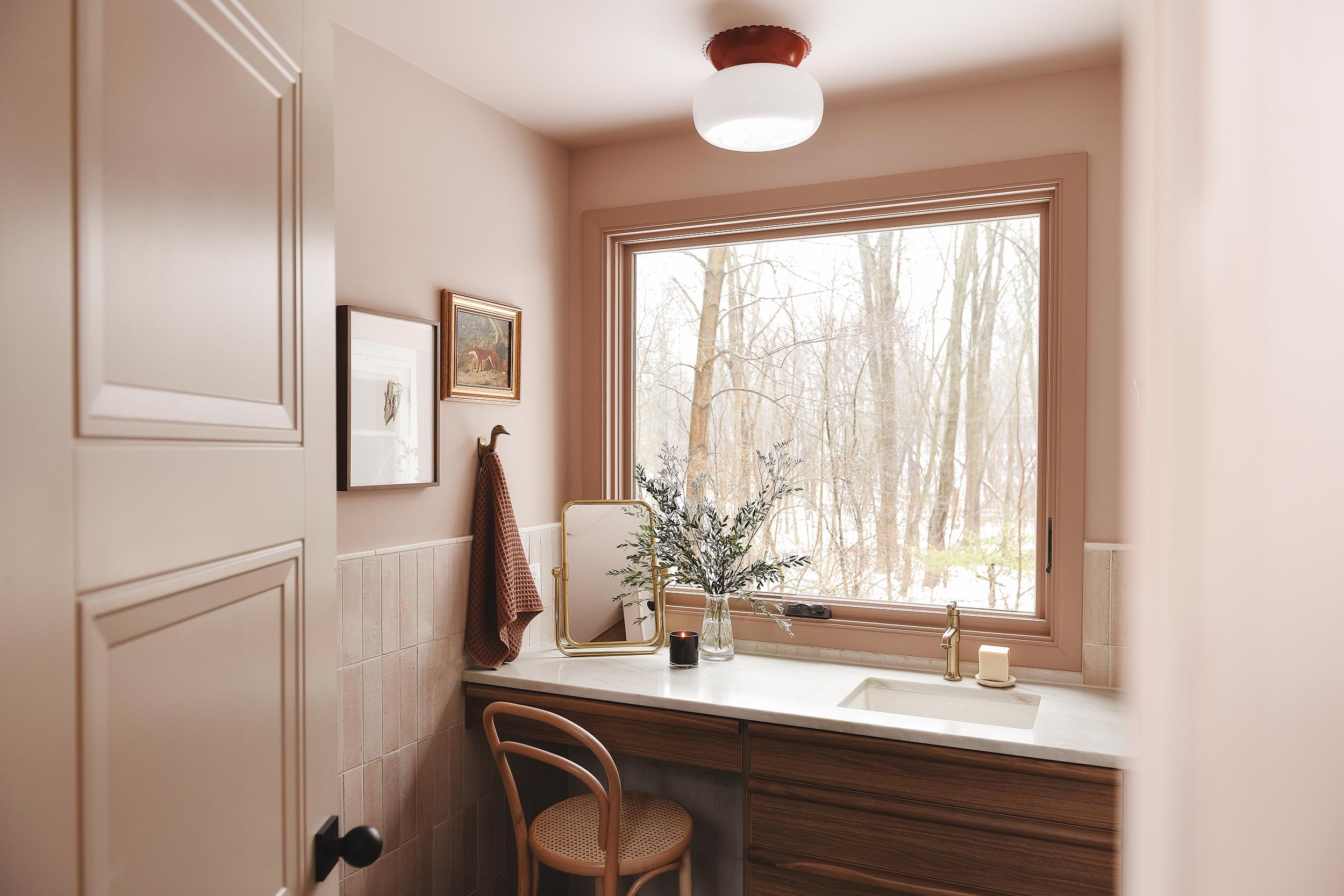 A peek into the pink and taupe bathroom | via Yellow Brick Home