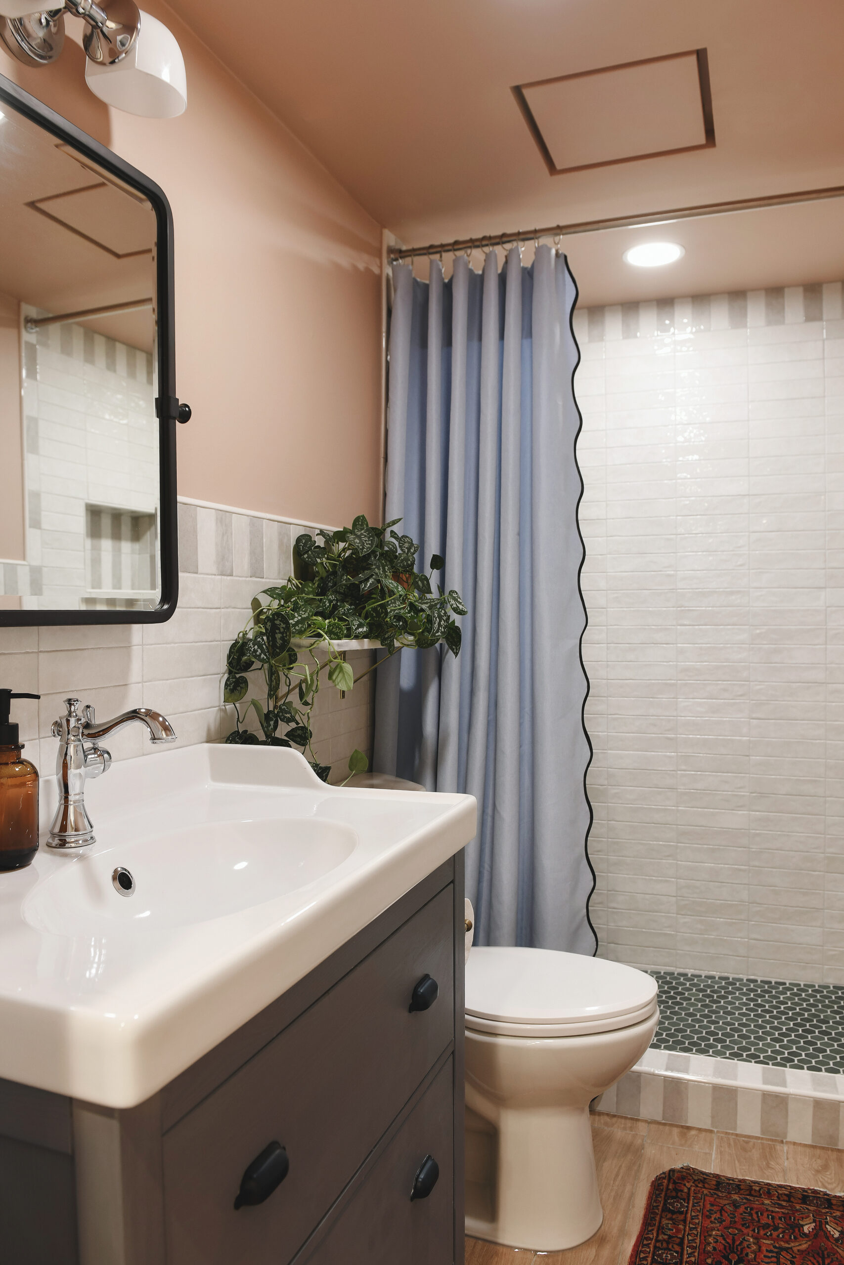 The finished garden apartment bathroom with a walk in shower and lots of color // via Yellow Brick Home