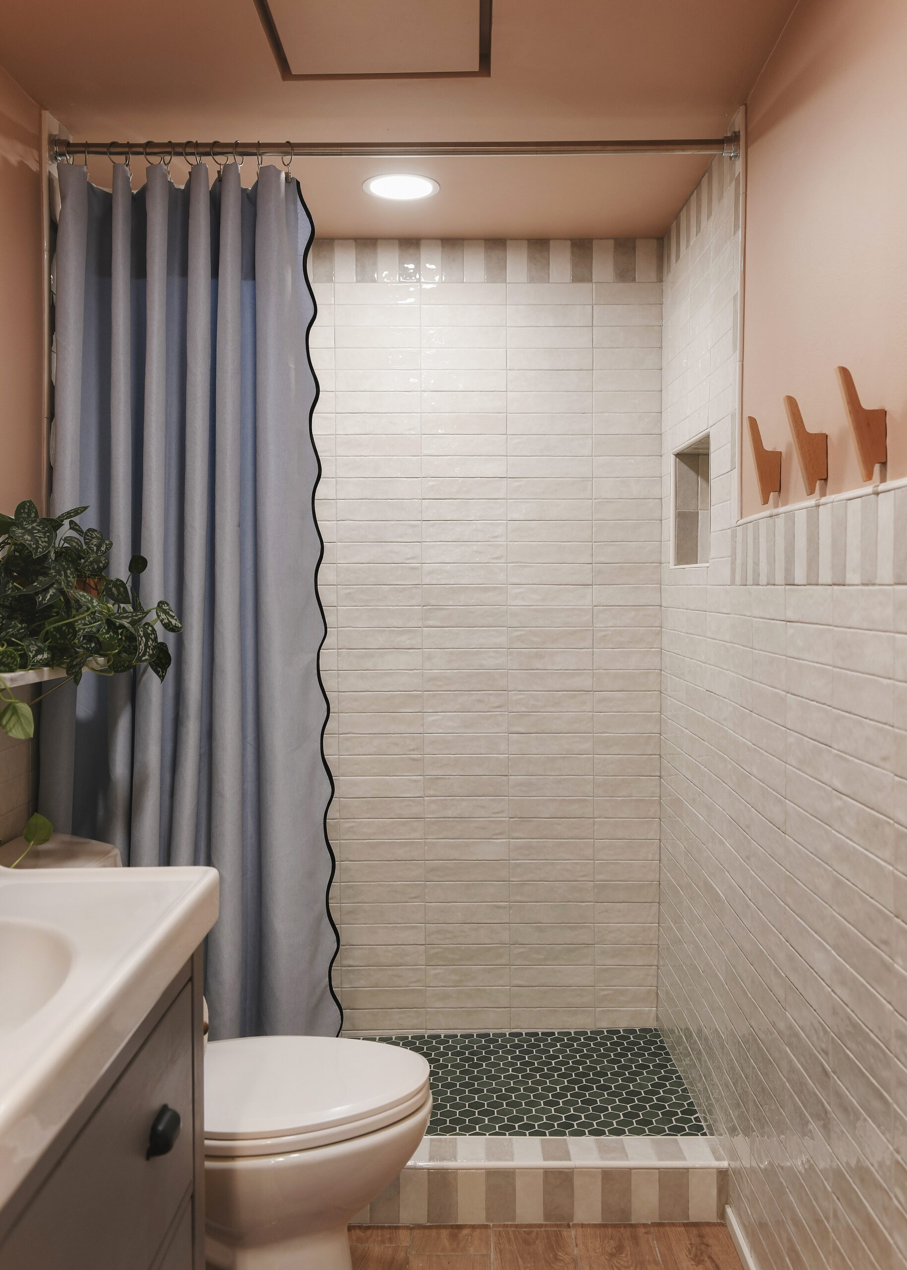 The completed bathroom with additional lighting, a raised ceiling, fresh tile and a whole lot of color // via Yellow Brick Home