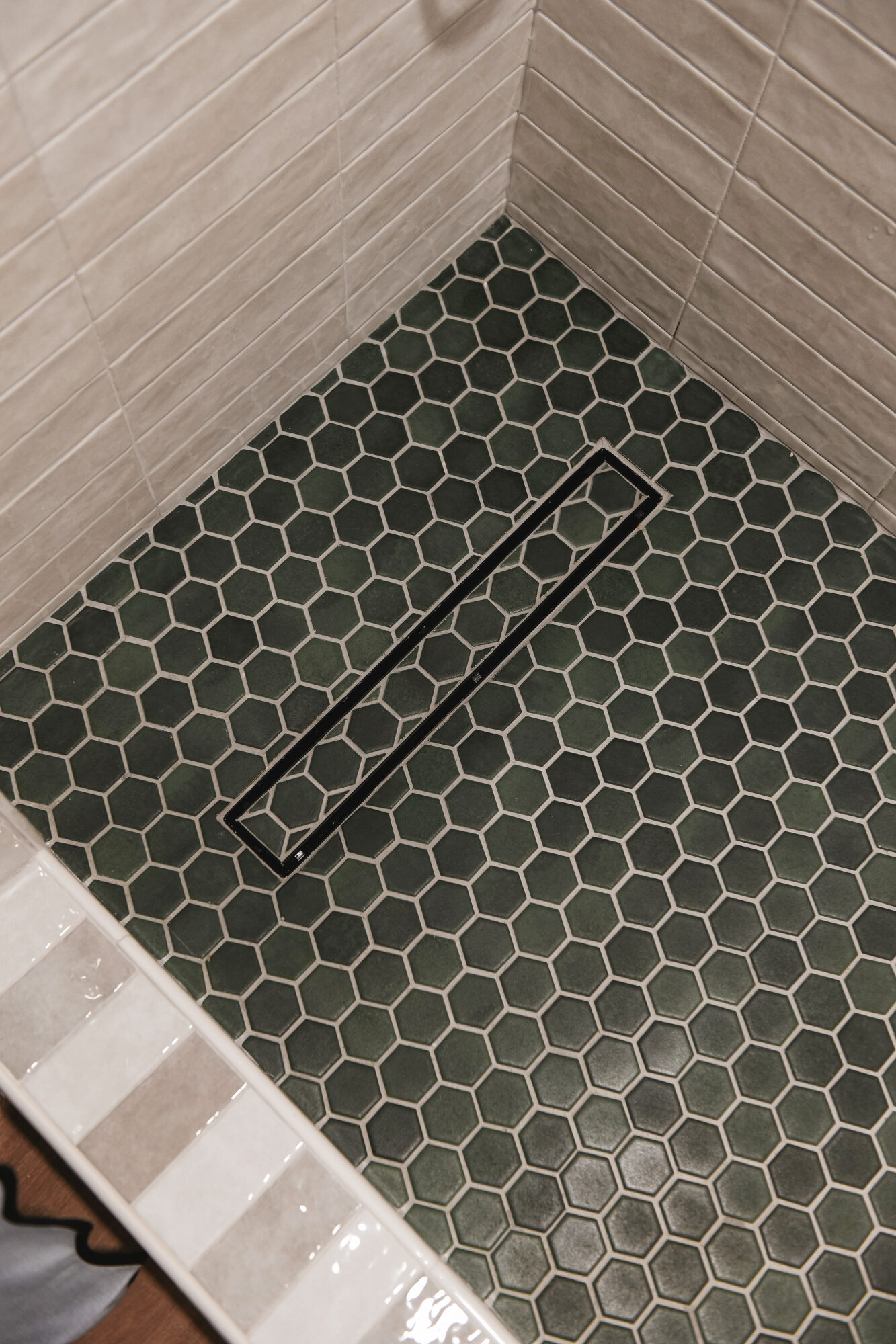 We chose a linear, inset drain for a seamless look on the shower floor // via Yellow Brick Home