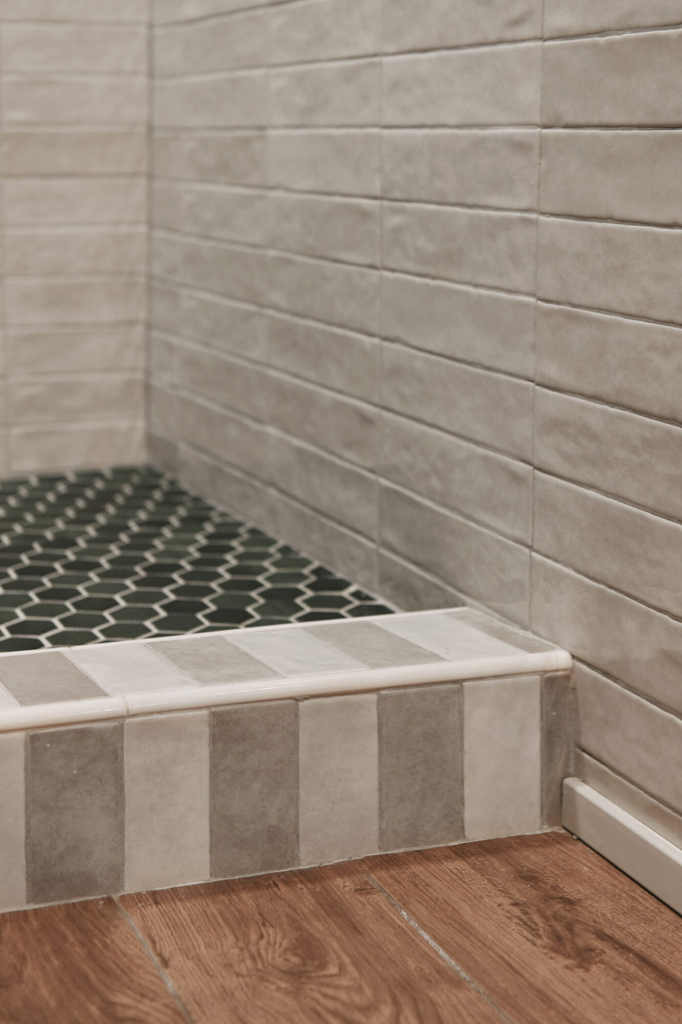 The weathered white tile against the green matte hex floor // via Yellow Brick Home