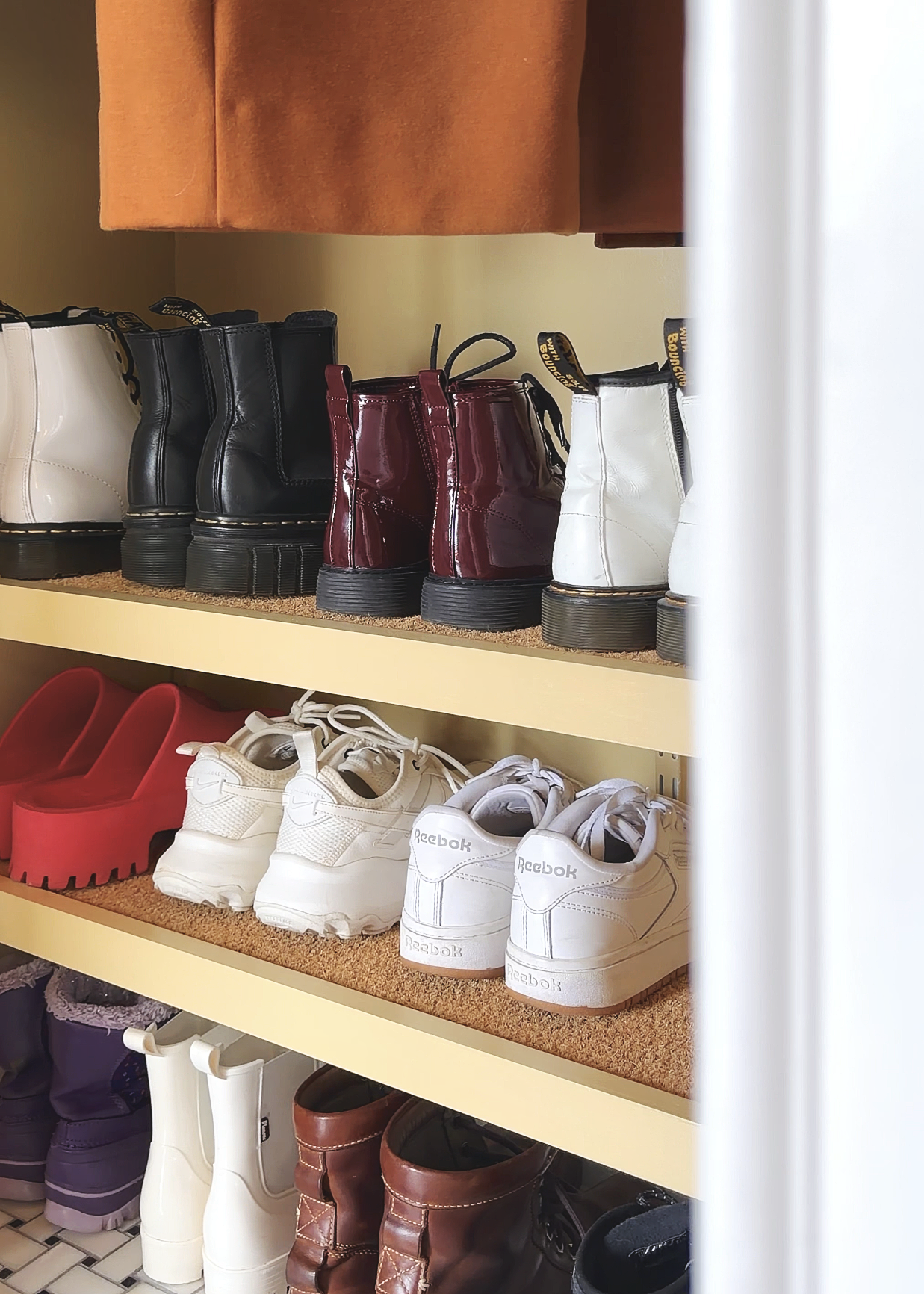 The shoe shelves in our freshly organized coat closet // via Yellow Brick Home